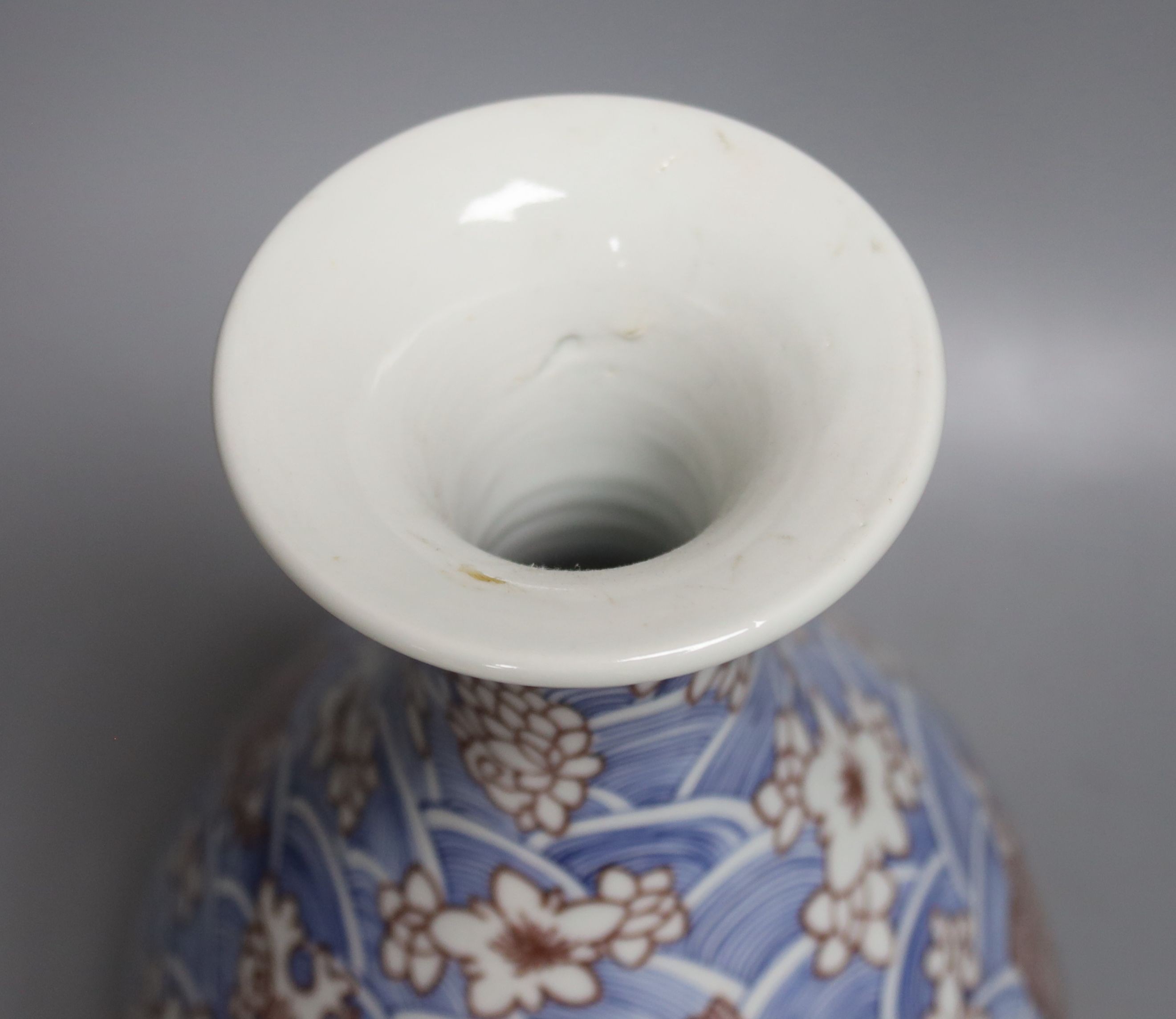 A Chinese underglaze blue and copper red pear-shaped vase, 31 cms high.